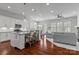 Open-concept kitchen with white cabinets, a large island, and modern appliances flowing into the living area at 329 Brambling Ct, Monroe, NC 28110