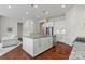 Open kitchen features stainless steel appliances and a central island with sink and storage at 329 Brambling Ct, Monroe, NC 28110