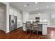 Bright kitchen boasts stainless steel appliances, a granite island with seating, and pendant lighting at 329 Brambling Ct, Monroe, NC 28110