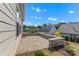 Back patio with stone wall featuring new landscaping and backyard at 329 Brambling Ct, Monroe, NC 28110