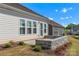 Back patio with stone wall featuring new landscaping at 329 Brambling Ct, Monroe, NC 28110