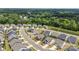 A planned neighborhood is featured with houses, lawns, driveways, streets, and landscaping at 329 Brambling Ct, Wesley Chapel, NC 28110