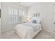 Comfortable bedroom with plantation shutters, a white bedspread, and a calm, inviting atmosphere at 329 Brambling Ct, Wesley Chapel, NC 28110