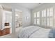 Bright bedroom featuring plantation shutters and ensuite bathroom with white marble at 329 Brambling Ct, Wesley Chapel, NC 28110