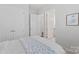 Bedroom view of the ensuite bathroom with white marble floors and vanity at 329 Brambling Ct, Wesley Chapel, NC 28110