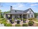Exterior view of clubhouse with covered seating, fire pit and ample comfortable seating at 329 Brambling Ct, Wesley Chapel, NC 28110