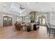 Clubhouse living room featuring a stone fireplace, high ceilings, and comfortable seating at 329 Brambling Ct, Wesley Chapel, NC 28110