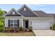 A close-up view of the home's exterior, showcasing its architectural details and landscaping at 329 Brambling Ct, Wesley Chapel, NC 28110