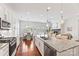 Modern kitchen with stainless steel appliances, granite countertops, and view to dining and living spaces with lots of natural light at 329 Brambling Ct, Wesley Chapel, NC 28110