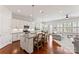 Modern kitchen with stainless steel appliances, white cabinetry, granite countertops, a spacious island with barstool seating at 329 Brambling Ct, Wesley Chapel, NC 28110