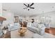 Bright living room featuring a fireplace, couches, ceiling fan, and an open floor plan to the kitchen and dining area at 329 Brambling Ct, Wesley Chapel, NC 28110