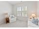 Inviting sitting room with plantation shutters, a comfortable sofa, armchair, and charming decor details creating a relaxing atmosphere at 329 Brambling Ct, Wesley Chapel, NC 28110