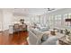 Bright, open-concept living space featuring hardwood floors, and white cabinets with granite countertops at 329 Brambling Ct, Wesley Chapel, NC 28110