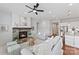 Cozy living room with a stone fireplace, plush seating, and ample natural light, creating a relaxing atmosphere at 329 Brambling Ct, Wesley Chapel, NC 28110