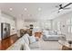 Bright, open-concept living space featuring hardwood floors, and white cabinets with granite countertops at 329 Brambling Ct, Wesley Chapel, NC 28110