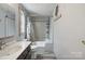 Bathroom with a shower-tub combo, wood look floors, and a white sink with vanity at 351 Fletcher Rd, Union Grove, NC 28689