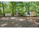 Charming home exterior with a welcoming front porch and storage shed nestled in a wooded lot at 351 Fletcher Rd, Union Grove, NC 28689