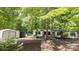 Exterior view of a single-story home with an outbuilding surrounded by mature trees at 351 Fletcher Rd, Union Grove, NC 28689