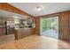 Bright kitchen features wood paneled breakfast bar with sliding glass doors and stainless steel refrigerator at 351 Fletcher Rd, Union Grove, NC 28689
