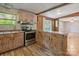 Well-lit kitchen with stainless steel appliances, light-colored cabinetry, decorative back splash and laminate wood floors at 351 Fletcher Rd, Union Grove, NC 28689