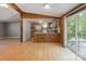 Bright kitchen and dining area with wood paneling, laminate floors, and sliding door access to the back deck at 351 Fletcher Rd, Union Grove, NC 28689