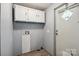 Utility room with laminate wood floors, white cabinets, and hookups for a washer and dryer at 351 Fletcher Rd, Union Grove, NC 28689