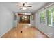 Spacious living area featuring laminate floors, natural light, and a view into the kitchen at 351 Fletcher Rd, Union Grove, NC 28689