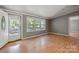 Bright living room with wood-look flooring, neutral paint, large windows, and natural light, ready for your personal touch at 351 Fletcher Rd, Union Grove, NC 28689