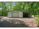 Exterior of the metal outbuilding with a garage door and open bay at 351 Fletcher Rd, Union Grove, NC 28689