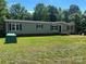 Charming home with green siding, black shutters, and a well-manicured lawn at 353 Quail Pointe Dr, Salisbury, NC 28147