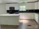 Modern kitchen with white cabinets, quartz countertops and stainless steel appliances at 353 Quail Pointe Dr, Salisbury, NC 28147