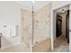 Luxurious bathroom featuring a glass enclosed shower and walk-in closet at 404 Basingdon Ct, Waxhaw, NC 28173