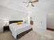 Spacious bedroom features tray ceiling, neutral carpet, and an adjoining ensuite bathroom at 404 Basingdon Ct, Waxhaw, NC 28173