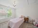 Cozy bedroom with pink accents, a bright window, and neutral carpet, featuring a teddy bear at 404 Basingdon Ct, Waxhaw, NC 28173