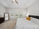 Bright bedroom features a large window, ceiling fan, and neutral carpet at 404 Basingdon Ct, Waxhaw, NC 28173