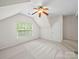 Bright bedroom with neutral carpet, a ceiling fan, and a window bringing in natural light at 404 Basingdon Ct, Waxhaw, NC 28173