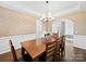 Elegant dining room featuring a wooden table, modern chandelier, and decorative wallpaper at 404 Basingdon Ct, Waxhaw, NC 28173