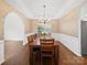 Bright dining room featuring hardwood floors, decorative wallpaper, and a large window at 404 Basingdon Ct, Waxhaw, NC 28173