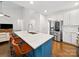 Stylish kitchen island with seating, stainless steel appliances, and an open floor plan at 404 Basingdon Ct, Waxhaw, NC 28173