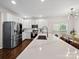 Spacious open kitchen featuring a large island, stainless steel appliances, and eat-in dining area at 404 Basingdon Ct, Waxhaw, NC 28173
