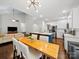 Open-concept kitchen and dining area with stainless steel appliances and a large center island at 404 Basingdon Ct, Waxhaw, NC 28173