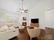 Bright living room with fireplace, hardwood floors, and comfortable seating area at 404 Basingdon Ct, Waxhaw, NC 28173