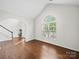 Bright living room with hardwood floors, arched doorway, and a large window with natural light at 404 Basingdon Ct, Waxhaw, NC 28173