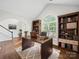 Stylish office with hardwood floors, built-in bookshelves, and a large window for ample natural light at 404 Basingdon Ct, Waxhaw, NC 28173