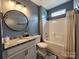 Well-maintained bathroom featuring a shower-tub combo, granite countertops, and a large mirror, perfect for daily routines at 413 Hunton Forest Dr, Concord, NC 28027
