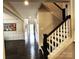 Inviting entryway features hardwood floors, staircase, and a view to the bright, naturally lit foyer at 413 Hunton Forest Dr, Concord, NC 28027