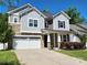 Attractive two-story home with stone and siding exterior, complemented by a spacious driveway at 413 Hunton Forest Dr, Concord, NC 28027