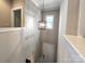Bright hallway illuminated by a pendant light, providing a seamless transition between rooms and adding a touch of elegance at 413 Hunton Forest Dr, Concord, NC 28027