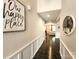 Elegant hallway featuring hardwood floors, wainscoting, and stylish decor at 413 Hunton Forest Dr, Concord, NC 28027
