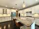 Bright and spacious kitchen with white cabinetry, granite countertops, island seating, and stainless steel appliances at 413 Hunton Forest Dr, Concord, NC 28027